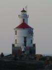 A hiker navigates the rocks on the way back from the lighthouse at Wisconsin Point
