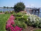 Prescott Park Gardens and Pier overlooking the Piscataqua River with the Portsmouth Naval Shipyard in the background.