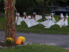 Ghosts on the lawn of someone's home at Halloween 
