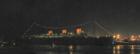 Night view of The Queen Mary from across the Bay at Parkers Lighthouse in Rainbow Harbor, Downtown Long Beach, California