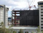 The main resort at The Cosmopolitan Resort Casino can be seen rising inbetween the Jockey Club.  Note the net that sits below this steel wall...Under it is above the Jockey Club pool area to protect swimmers during construction.  August 2007