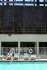 The Cosmopolitan Resort Casino grows tall just south of the Jockey Club pool.  May 2007