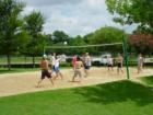 Teenagers playing sand volleyball at one of two sand volleyball courts