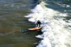 View looking down from the pier at local surfers.  