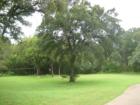 Rear area of Travis Country Blue Valley tennis courts includes a volleyball court and more picnic tables.