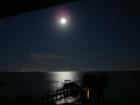 The moon setting in the west, over my neighbor's pier and Choctawhatchee Bay, with city lights visible from Destin, Sandestin, and Fort Walton Beach, Florida. 9-27-7