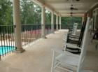Enjoy the quiet peacefulness of this community on the back deck of the clubhouse that overlooks the pool and lake.