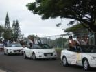 2007 Mililani High School homecoming court rides in style in the parade as it passes the shopping center