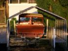 An old wood boat sits on Lake Minnetonka, waiting to touch the water.