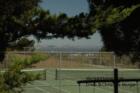 A view of San Francisco over the tennis courts in Hallmark Park.