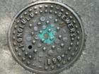 Historical sewer cover behind the State Library