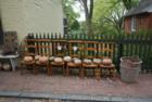 Prayer chairs for sale in front of a Main Street antique shop.  The pumpkins are free
