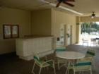 Here is a nice shady area by the Pool where you can snack and take a break from the sun. Tables and chairs at The Lakes at the BUFFS.