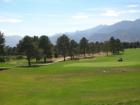 Kissing Camels Golf Course with a backdrop of the Rocky Mountains.