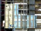 The first glass gets installed on Mandarin Oriental at MGM MIRAGE CityCenter as 3 construction workers look on.  October 2007.