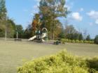 Trilogy Park's Summertime Park - Playground, Swings and a Field.  There's a small area toward the back that leads to some trails.