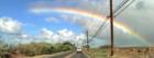 driving on the hana hiway on maui and seeing a bright rainbow over paia town on the north shore 