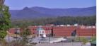 Pickens High School is uniquely situated in a private location, removed from the main road in a small valley with mountainous backdrop, as can be seen in this picture.