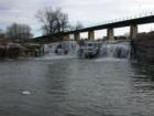 The falls at Falls Park.  An eagle soars overhead at upper left.