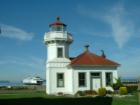 Lighthouse at Mukilteo with ferry preparing to dock.