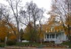 A splash of late autumn color surrounds a historic home in Fish Creek