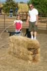 Little wranglers can practice on a hay bale at Book's Family Farm in Chico, CA.