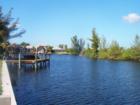 Looking down a typical SW Cape Coral Canal from a home's backyard.