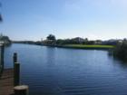 View down a Cape Coral canal home with 228' of seawall.