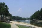 Edge of pool sits along side of a small beach to Lake Norman