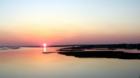 Sun setting over Bogue Sound crossing the bridge driving to Swansboro N C