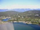 Aerial over the village of Bigfork, MT and Flathead Lake's Bigfork Bay.  The Swan Mountain Range is seen in the distance.