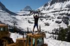 Cyclist stopped by snow in early spring. Going to The Sun Road, Glacier National Park