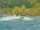 My son and nephew riding a jet ski on the lake near Searcy.