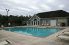 View of the pool and clubhouse available to the residents of Melrose Park in Charleston, SC.