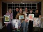 Some of the artist displaying their art at the Cinco Ranch Ladies Club meeting.  Photo by Liz Carter