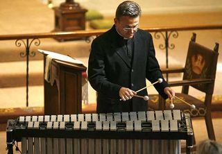 The Rev. Norm Freeman includes a vibe performance Sunday during his service at St. George's Episcopal Church in Laguna Hills. 