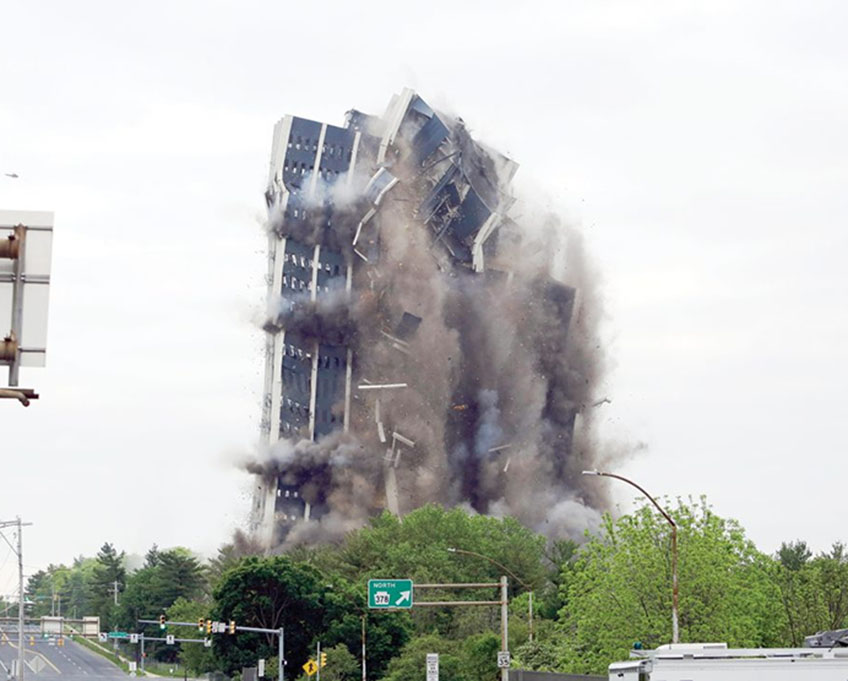 A series of explosive charges broke the steel bones of the 21-story building. Photo credit: Associated Press.