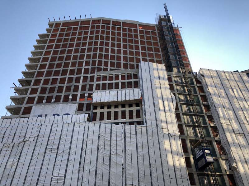 The slim reinforced concrete structure reached its 21-story parapet, and work is now shifting to the installation of its brick masonry façade. Photo by Michael Young