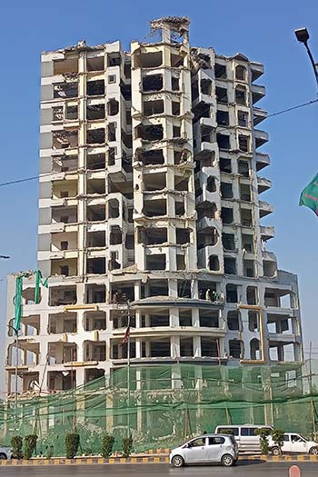 The two buildings were ordered demolished; one has been completely demolished and the other is underway. (c) MasterofMetaverse, CC-BY-SA.