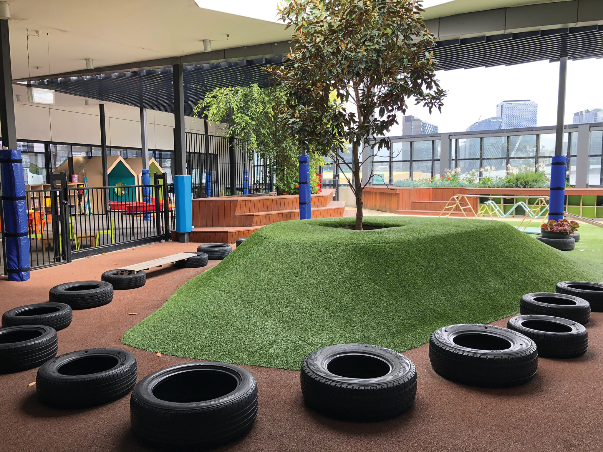 Figure 8. An artificial-turf mound provides naturalistic play experiences within the unconditioned building enclosure of School 1.