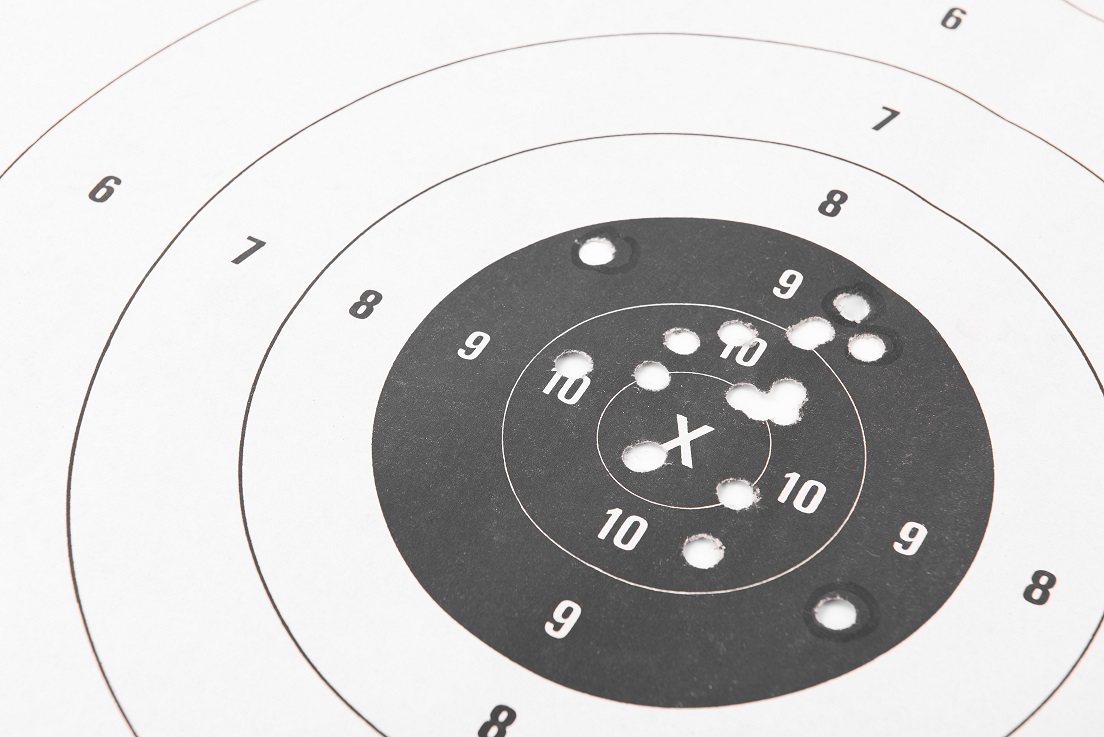 Close up of a shooting target and bullseye with bullet holes