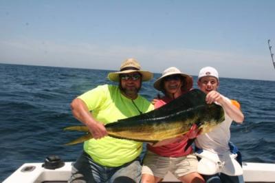 William Croft, Captain Kathy Brown, and Lane Croft holding Williams just caught dolphin. <br><br>CAPTAIN JUDY HELMEY<br>