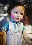 Doll_on_glass_shelf