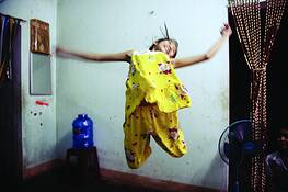 Child_jumping_in_a_home_built_on_de-mined_ground