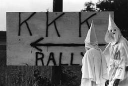 Kkk_in_front_of_sign