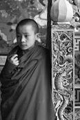 Tulku_leaning_on_post