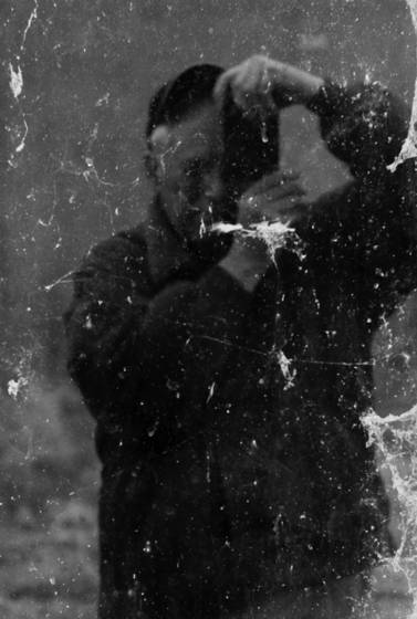 Self_portrait_in_a_dirty_window