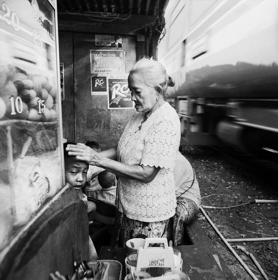 Elderly_woman_comforting_child_as_train_passes_by