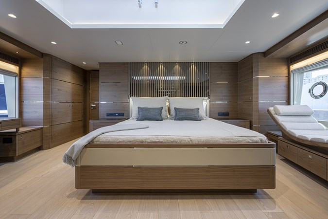 Master stateroom with large bed and lounger to port.