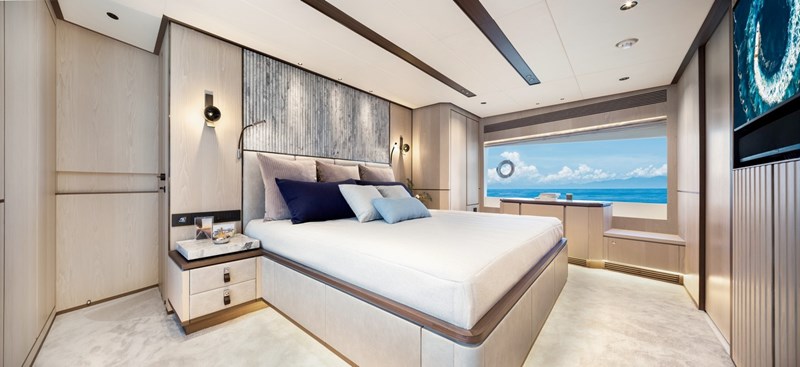 Large master stateroom with stone headboard.